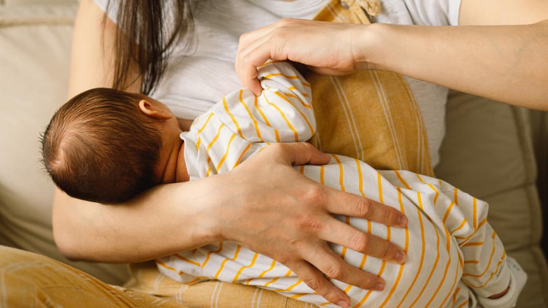 Mutter stillt ihr Baby. 