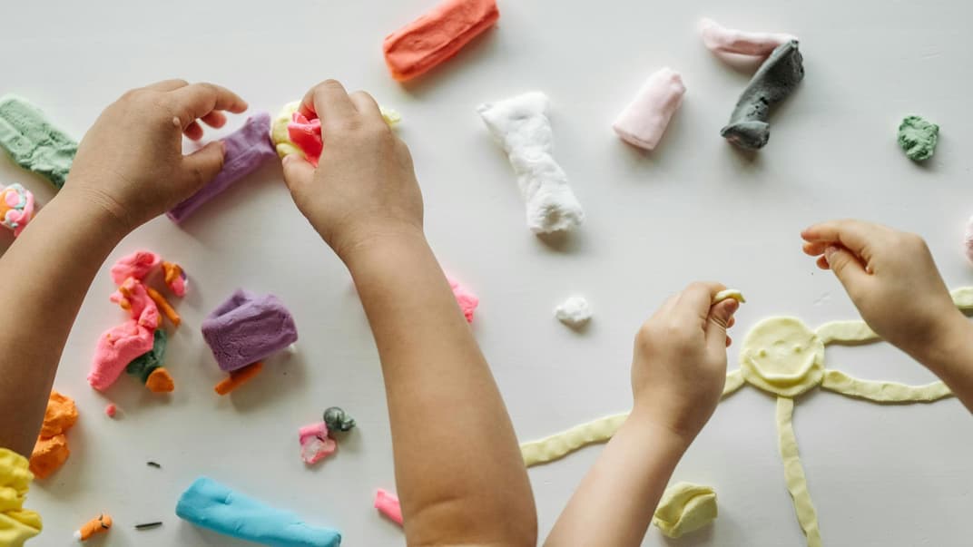 Kinder spielen mit Knete