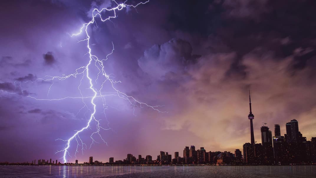Ein Blitz schlägt nahe einer Stadt ein.
