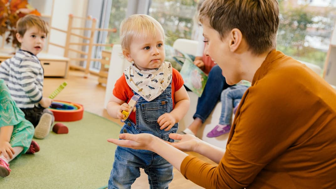 Etwa ein Drittel aller Kinder in Deutschland besuchen eine Kita oder Tagesmutter. Erzieherin mit Kindern in der Kita.