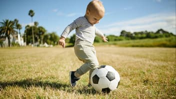 Kleines Kind spielt Fußball.