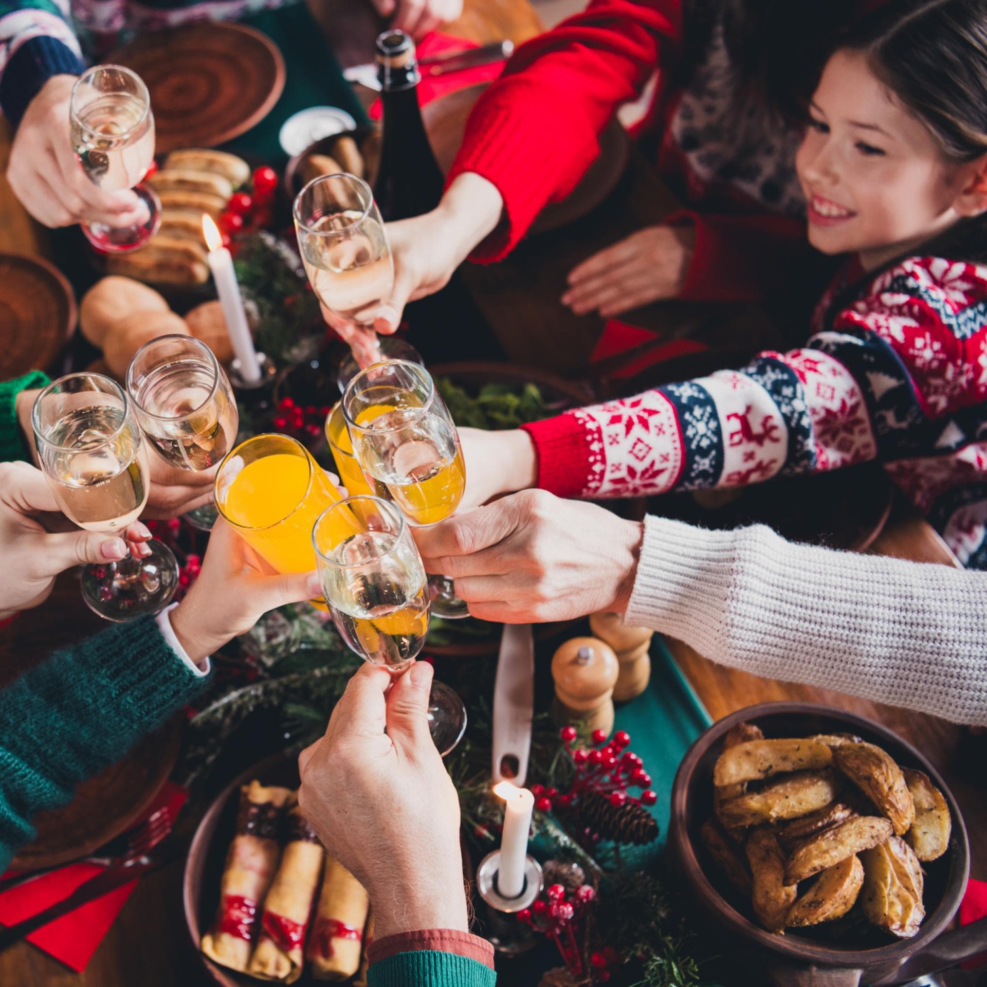 Zu Weihnachten stößt eine Familie mit Gläsern an. 
