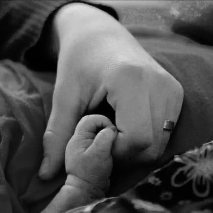 Frau hält Hand ihres Babys