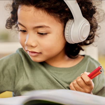 6-Jährige hört Musik beim Lernen.