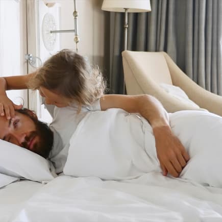 Mädchen öffnet dem Papa die Augen.
