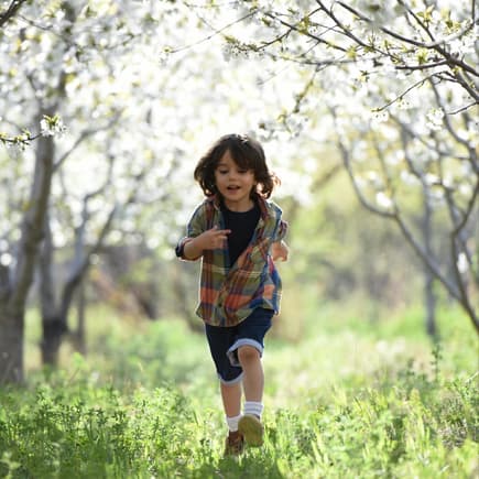 Kind läuft durch die Natur.