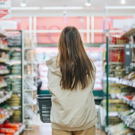 Eine Frau schlendert durch den Supermarkt