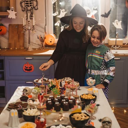Mutter und Kind betrachten ihr Halloween-Buffet.