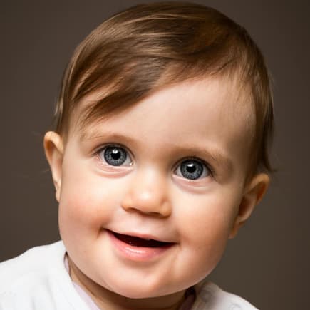 Ein süßer Baby-Junge lächelt in die Kamera. 