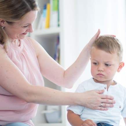 Microkinesi-Therapeutin Regina Mayer-Dangl bei der Untersuchung eines kleinen Patienten. 