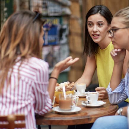Drei Frauen unterhalten sich beim Kaffee.