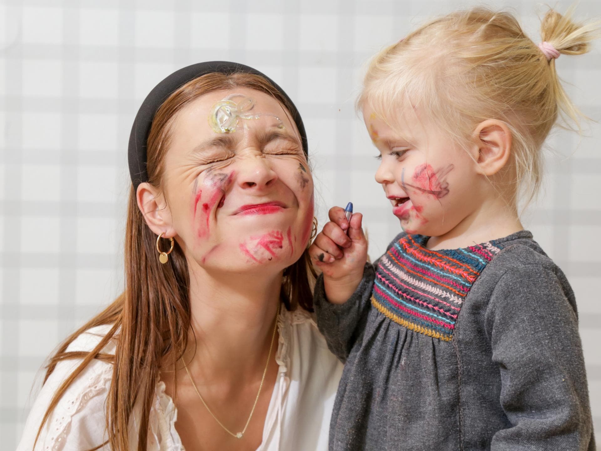 Mama und Tochter spielen mit Gesichtsfarbe. Mama und Tochter spielen mit Gesichtsfarbe.