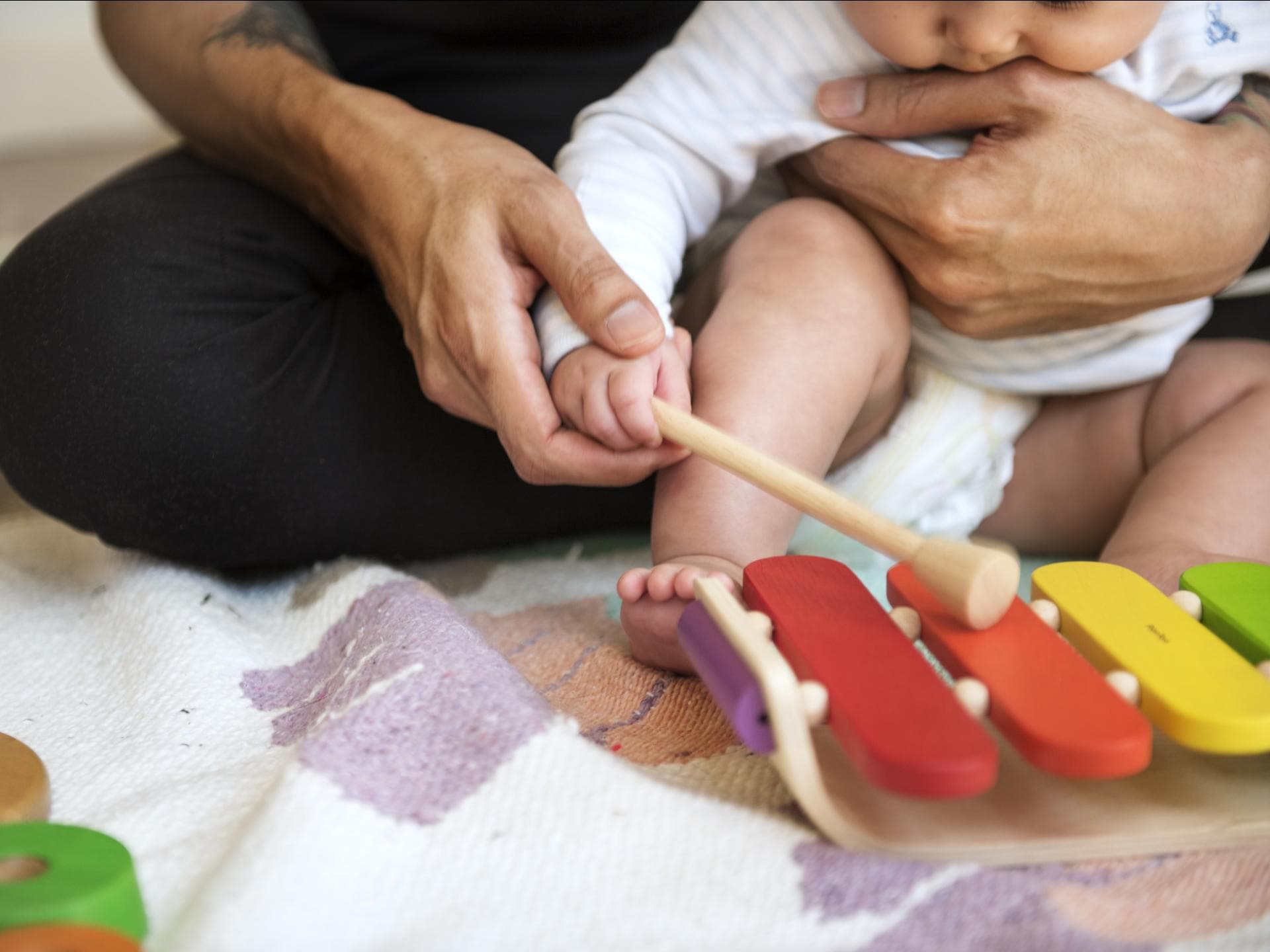Vater übt mit seinem Baby Xylophon-Spielen Vater übt mit seinem Baby Xylophon-Spielen