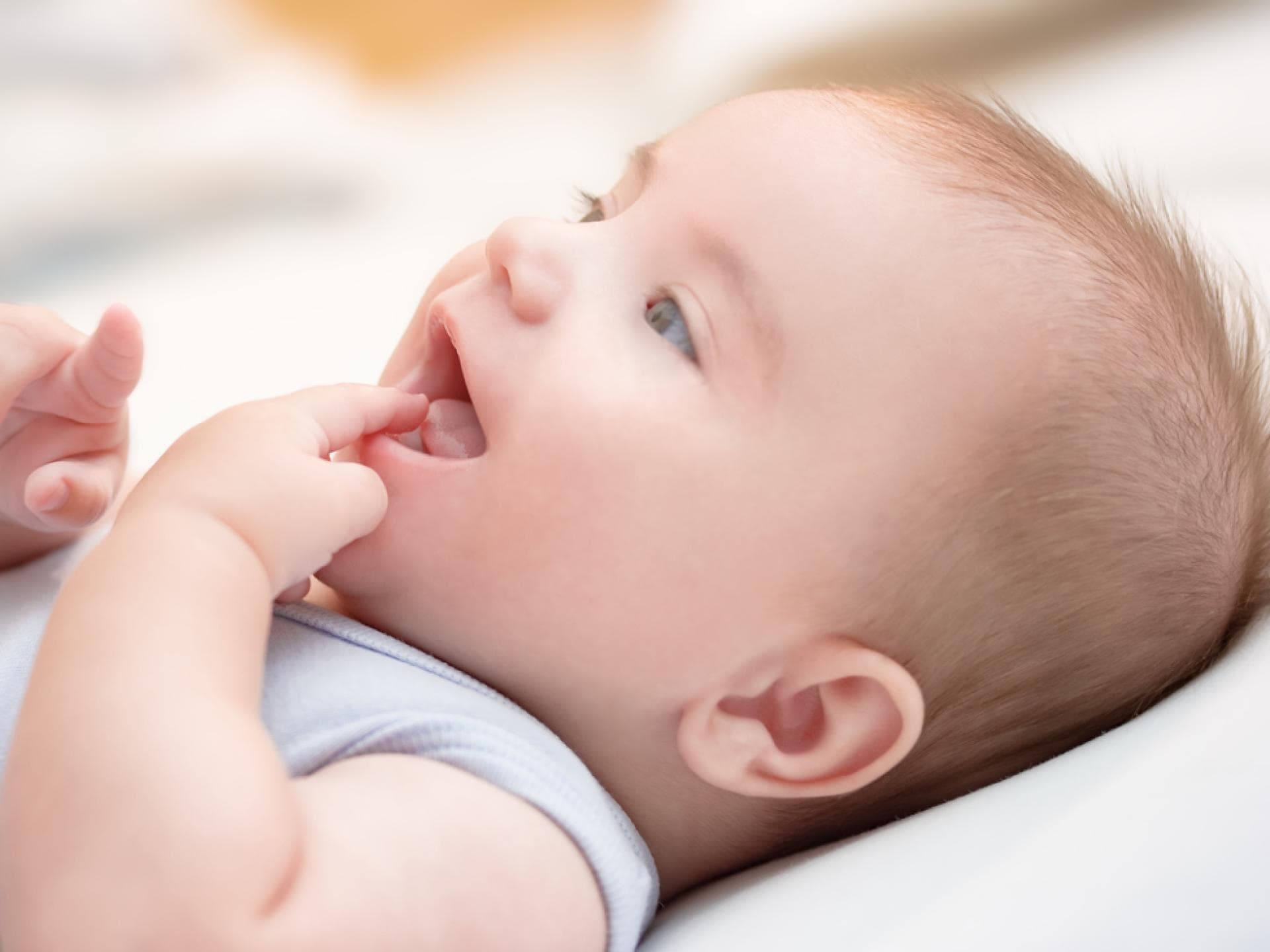 Baby saugt an seinem Finger – typisch für die orale Phase.