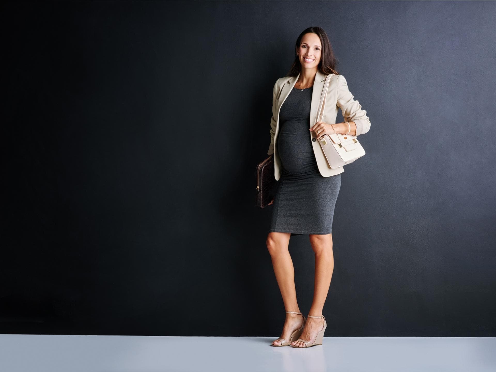 Schwangere im schicken Business-Outfit.