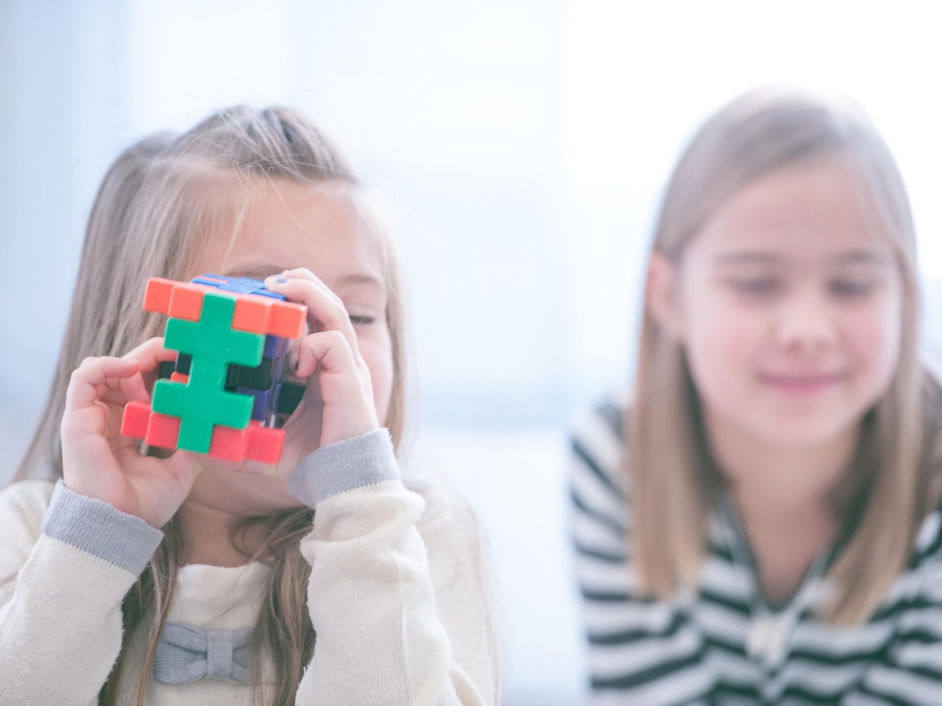 Zwei Mädchen, eins mit Spielzeug.
