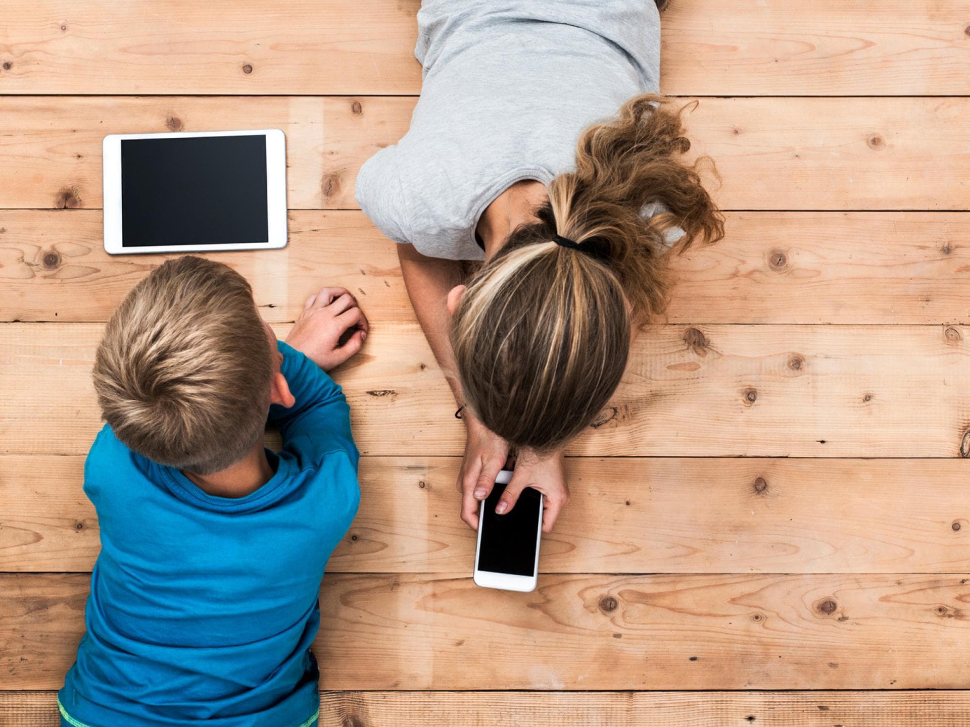 Ein verantwortungsbewusster Umgang mit Handy, Smartphone und Co. Zwei Kinder an mobilen Geräten.