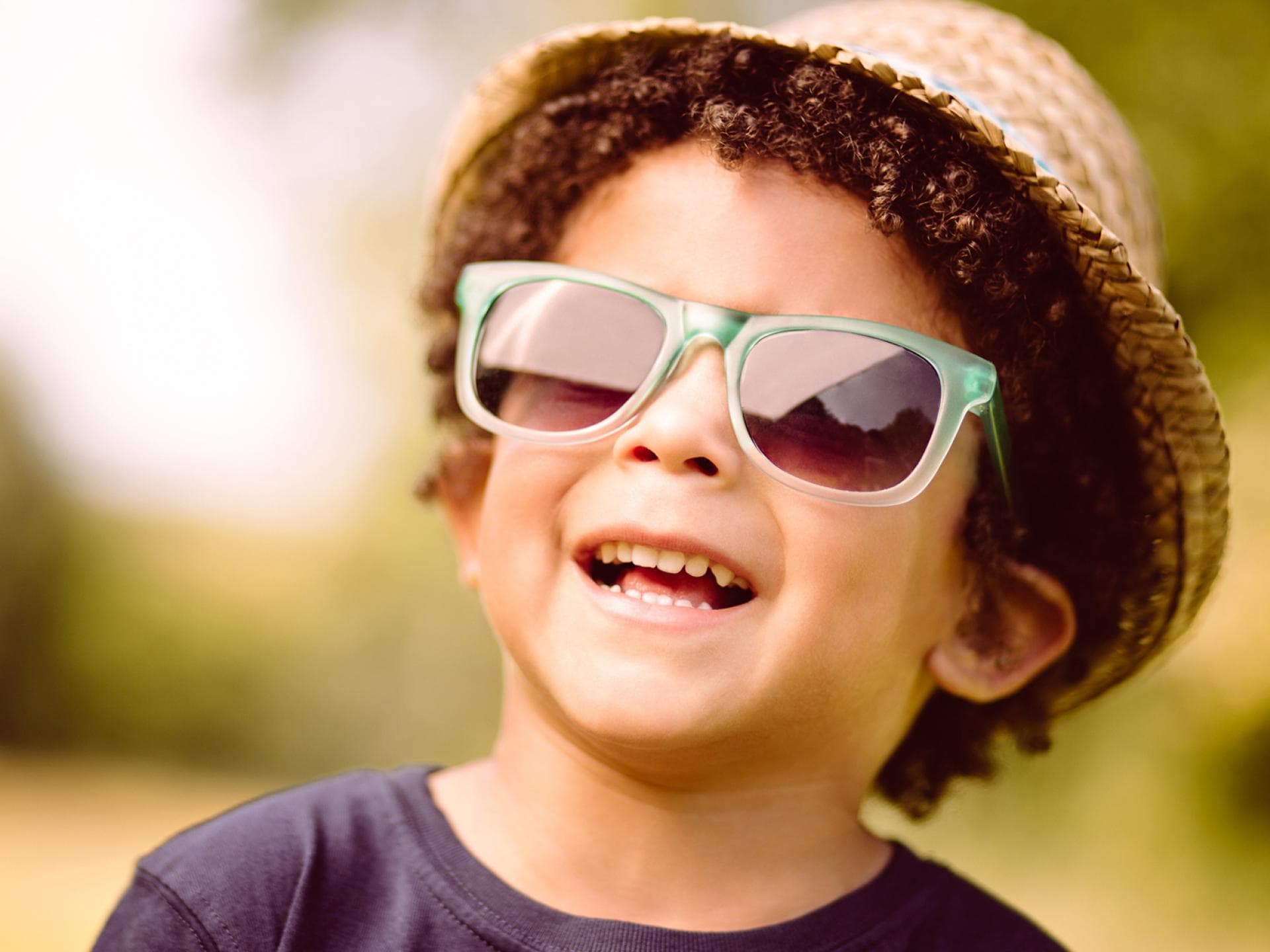Eine Sonnenbrille schützt empfindliche Kinderaugen.
