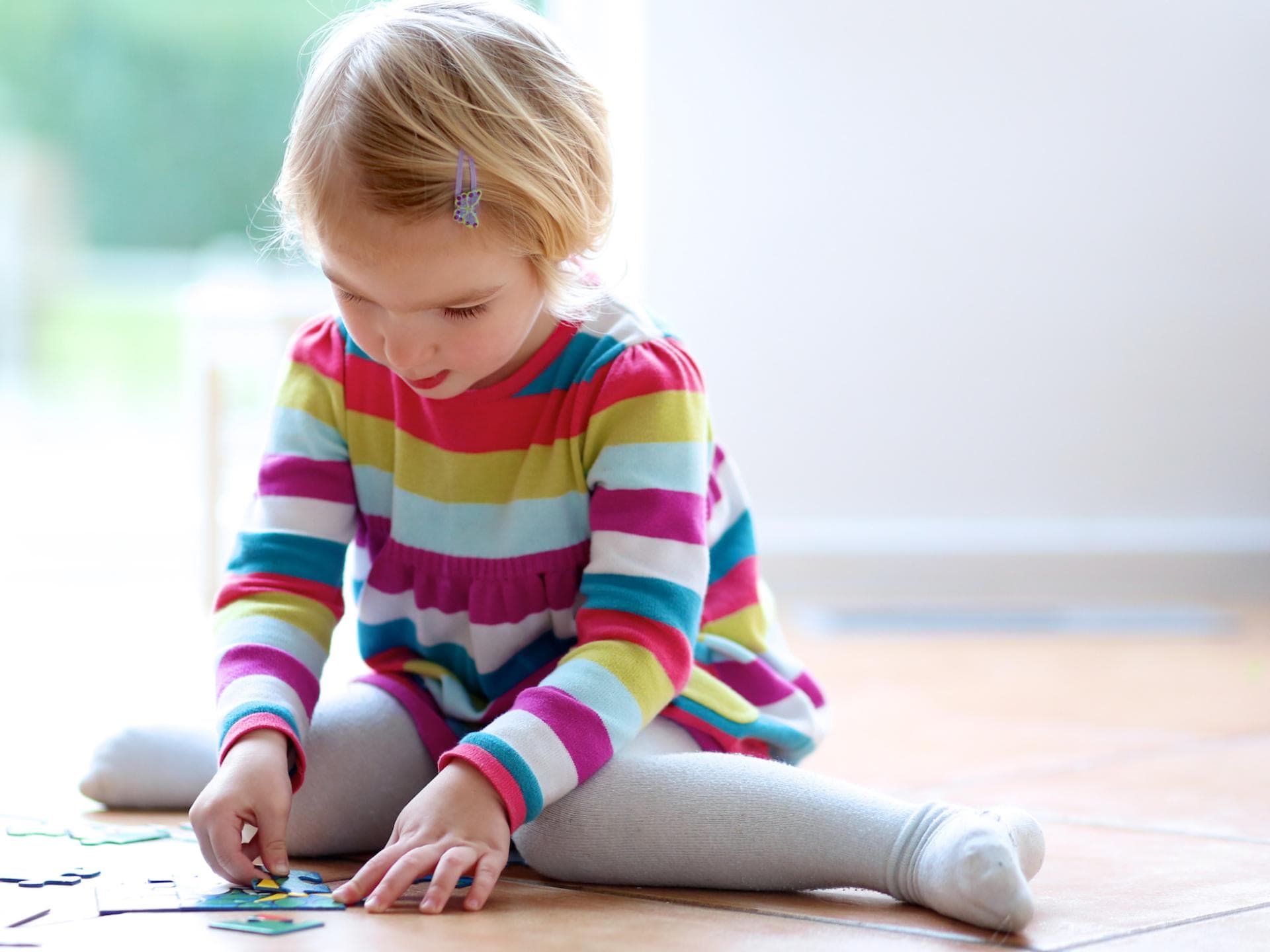Kinder sitzen gerne im W-Sitz, wenn sie am Boden spielen. 